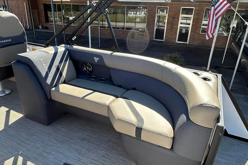 Slide: The Image of 2025 Viaggio Lago X-Q boat interior with curved seating and American flag. - 19