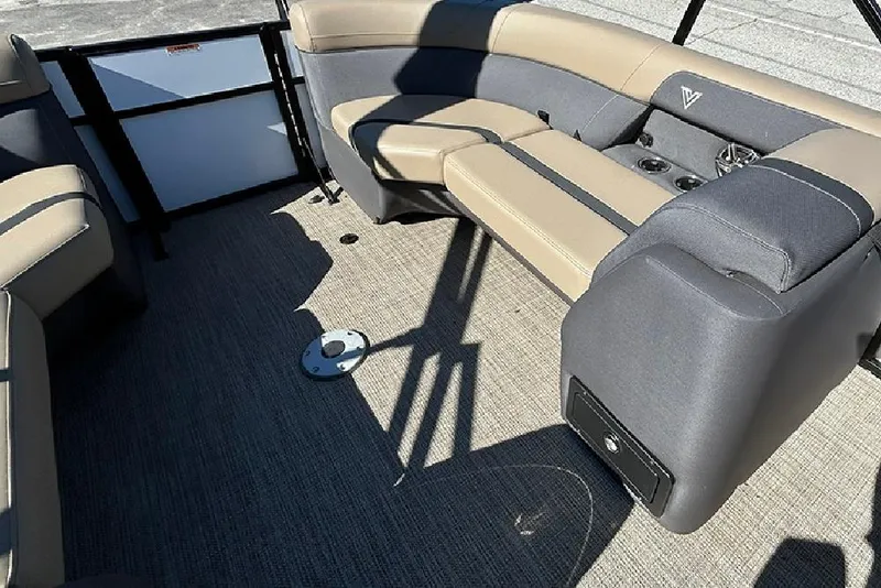 Slide: The Image of 2025 Viaggio Lago X-Q boat interior with beige and gray seating, cup holders, and carpeted floor. - 24