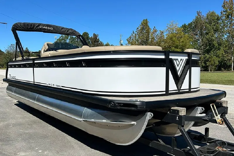 Slide: The Image of 2025 Viaggio Lago X-Q pontoon boat on trailer, parked outdoors. - 3