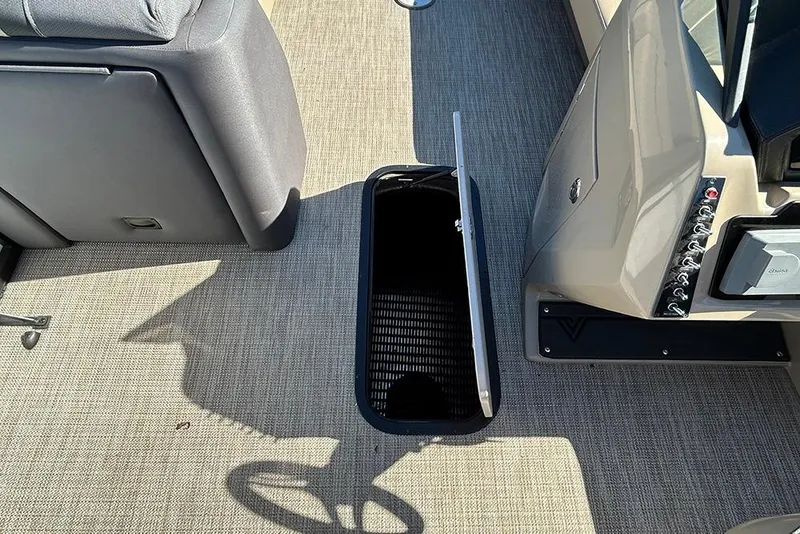 Slide: The Image of Viaggio Lago X-Q 2025 boat interior with open storage compartment and control panel. - 37