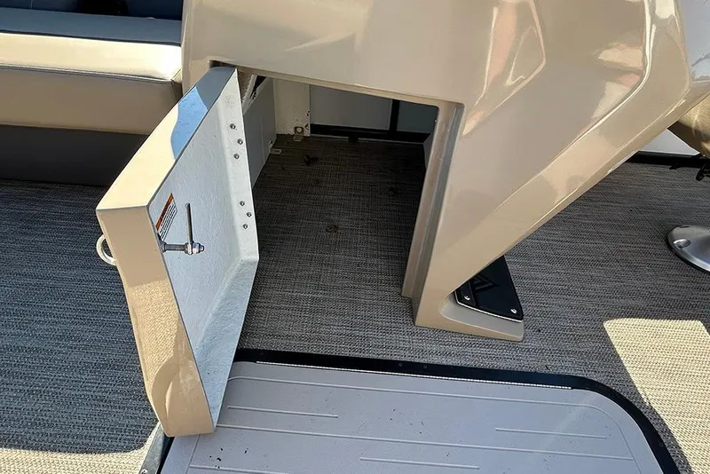 Slide: The Image of Open storage compartment on 2025 Viaggio Lago X-Q boat, featuring beige interior and carpeted flooring. - 39