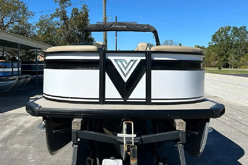 Slide: The Image of 2025 Viaggio Lago X-Q pontoon boat on trailer, front view, outdoors. - 4