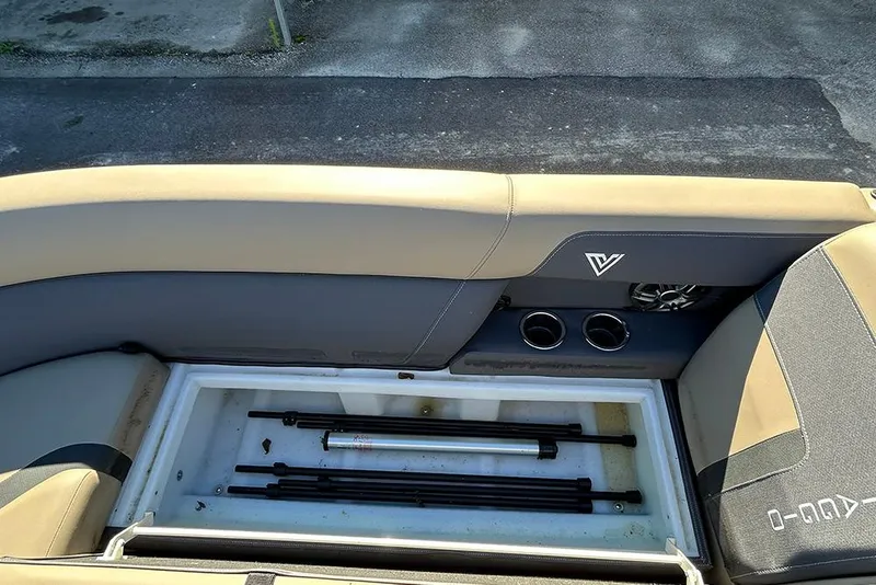 Slide: The Image of Storage compartment in 2025 Viaggio Lago X-Q boat with beige seating and cup holders. - 40
