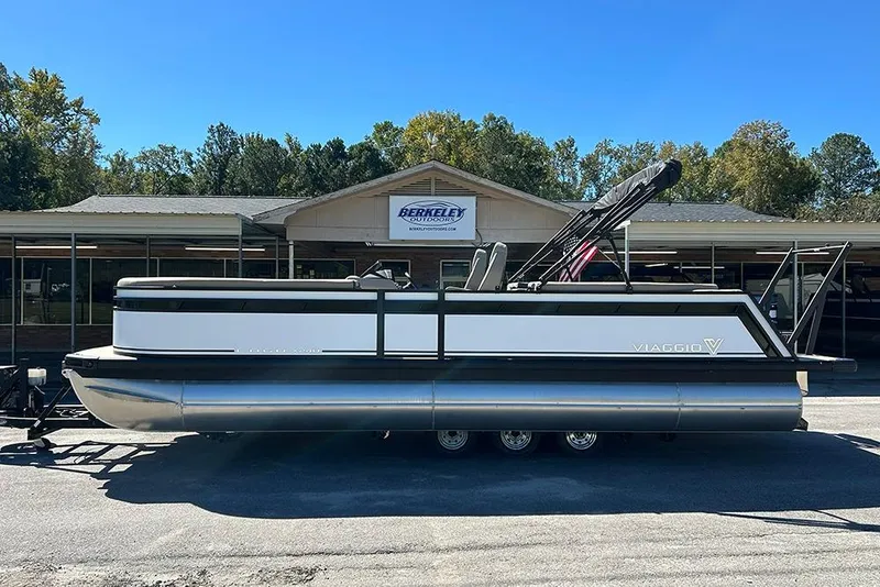 Slide: The Image of 2025 Viaggio Lago X-Q pontoon boat parked outside dealership. - 6