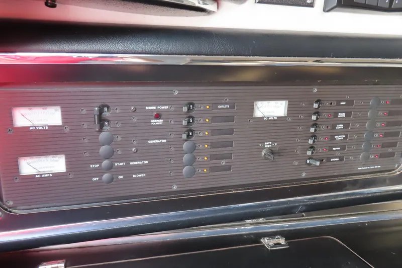 Slide: The Image of Control panel of a 1990 Wellcraft 38 Scarab boat, featuring AC and DC voltage meters. - 22