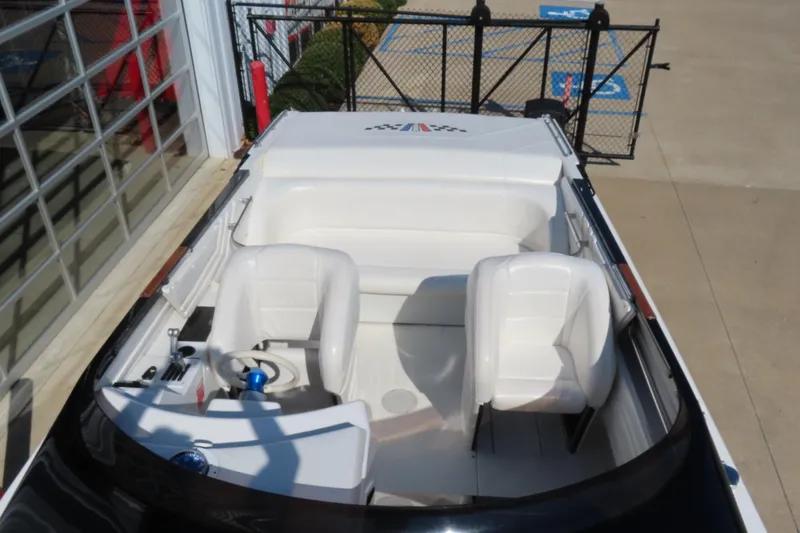 Slide: The Image of 1990 Wellcraft 38 Scarab boat interior with white seating and steering wheel. - 28