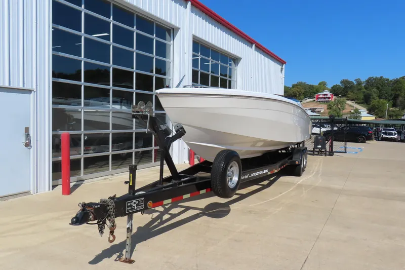 Slide: The Image of 1990 Wellcraft 38 Scarab boat on trailer outside a modern garage. - 3