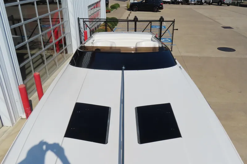 Slide: The Image of 1990 Wellcraft 38 Scarab boat, white exterior, parked near a garage. - 9