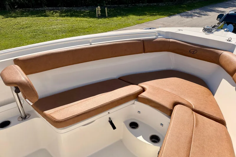 Slide: The Image of 2015 Sailfish 290 CC boat with brown cushioned seating in the bow area. - 10