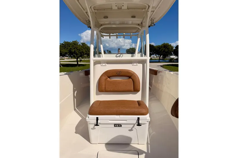 Slide: The Image of 2015 Sailfish 290 CC boat interior with cushioned seating and Yeti cooler. - 12