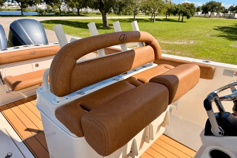 Slide: The Image of 2015 Sailfish 290 CC boat with tan leather seating and dual engines. - 16