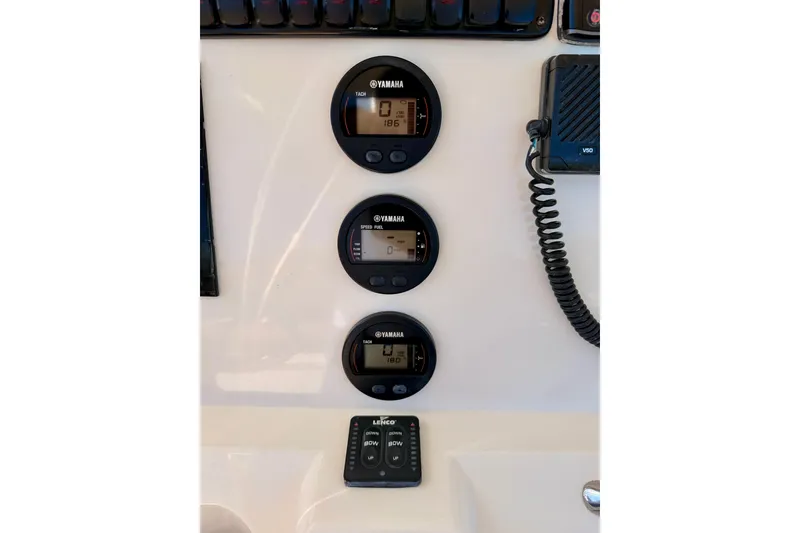 Slide: The Image of 2015 Sailfish 290 CC dashboard with Yamaha gauges and Lenco controls. - 19