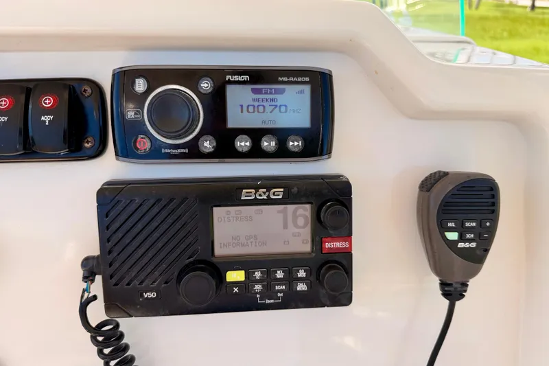 Slide: The Image of 2015 Sailfish 290 CC boat dashboard with Fusion radio and B&G V50 marine communication system. - 22