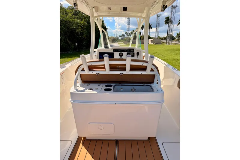 Slide: The Image of 2015 Sailfish 290 CC boat interior with rod holders and control panel. - 24