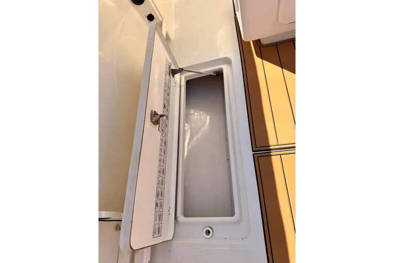 Slide: The Image of Open storage compartment on 2015 Sailfish 290 CC boat deck. - 37