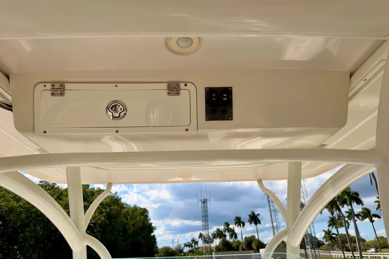 Slide: The Image of 2015 Sailfish 290 CC boat console with storage compartment and control panel. - 38