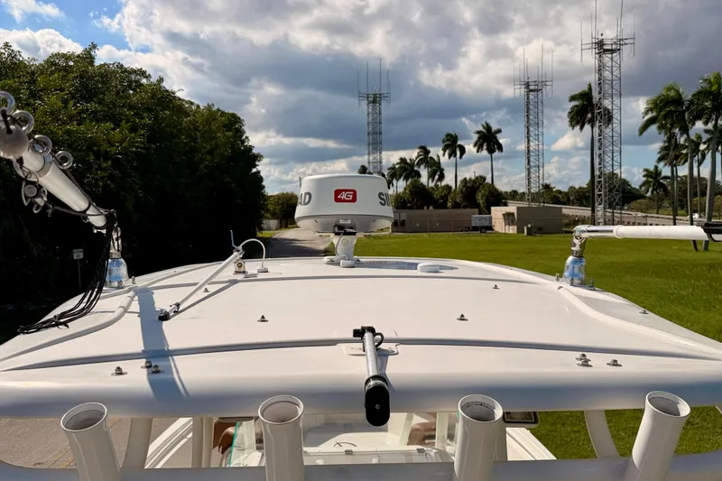 Slide: The Image of 2015 Sailfish 290 CC boat with radar, antennas, and palm trees in the background. - 40