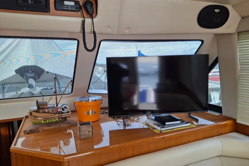 Slide: The Image of Cozy bedroom in 2000 Riviera Enclosed Flybridge yacht with patterned bedding and decorative pillow. - 17