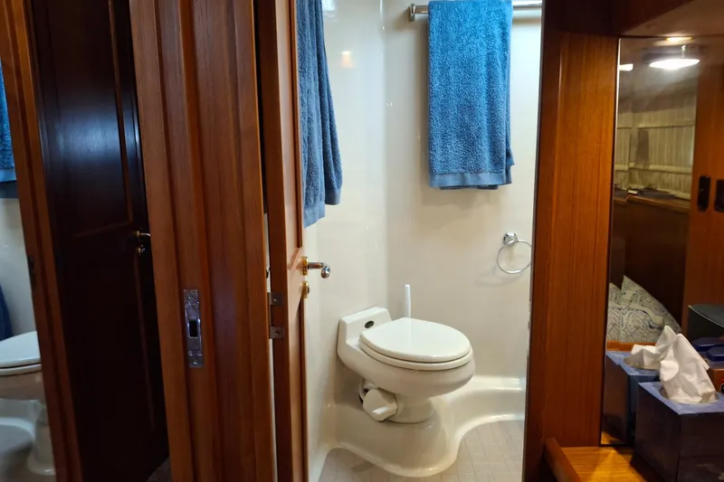 Slide: The Image of Bathroom interior of 2000 Riviera Enclosed Flybridge yacht with towel and toiletries. - 19