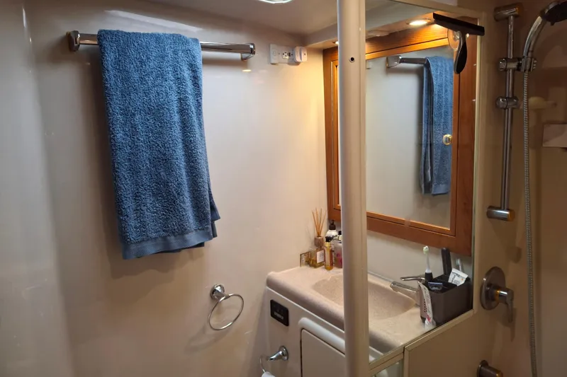 Slide: The Image of Bathroom interior of 2000 Riviera Enclosed Flybridge yacht with shower and toiletries. - 20