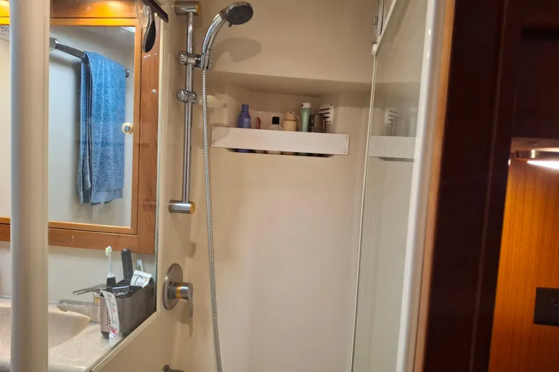 Slide: The Image of Small cabin with bunk beds and storage on a 2000 Riviera Enclosed Flybridge boat. - 21