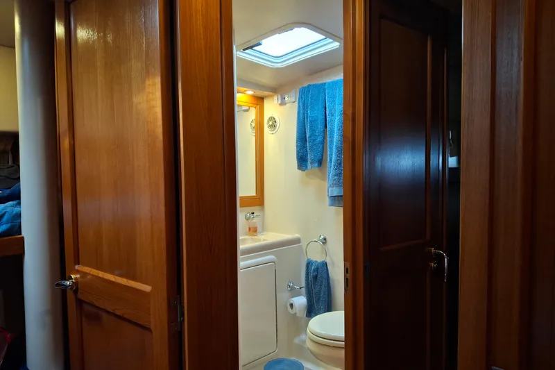 Slide: The Image of Bathroom interior of 2000 Riviera Enclosed Flybridge yacht with shower and sink. - 23