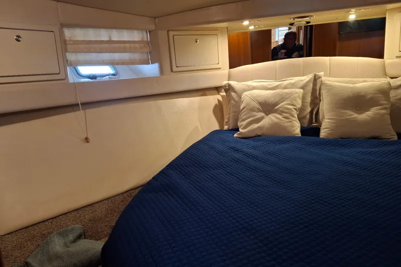 Slide: The Image of 2000 Riviera Enclosed Flybridge yacht interior with ladder and open compartment. - 27