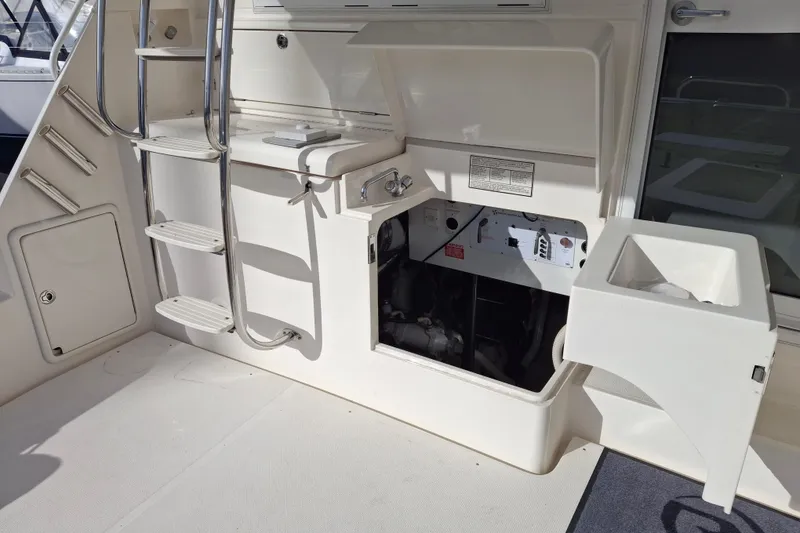 Slide: The Image of Engine room of 2000 Riviera Enclosed Flybridge yacht, showcasing mechanical components and systems. - 28