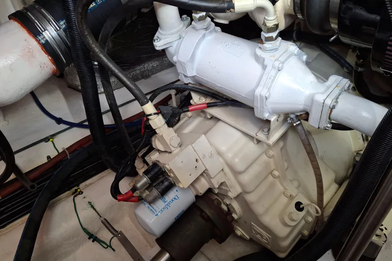 Slide: The Image of Engine compartment of 2000 Riviera Enclosed Flybridge with visible air filter and hoses. - 32