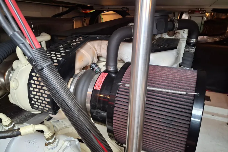 Slide: The Image of Engine room of 2000 Riviera Enclosed Flybridge showing fuel filters and piping system. - 33