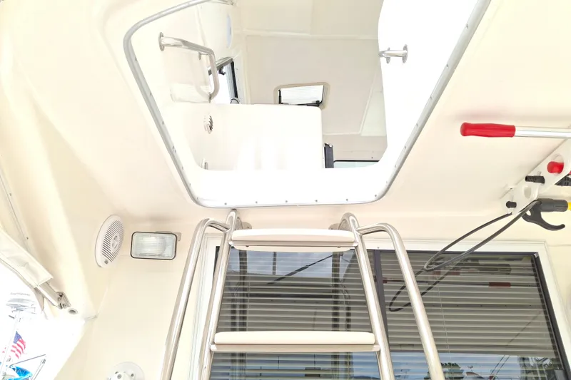 Slide: The Image of Luxurious 2000 Riviera Enclosed Flybridge interior with beige seating and decorative pillows. - 36