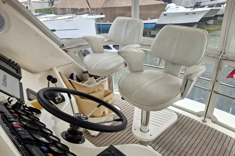 Slide: The Image of 2000 Riviera Enclosed Flybridge helm with Garmin navigation system and steering wheel. - 41