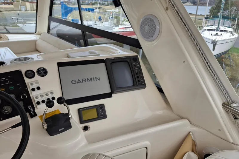 Slide: The Image of 2000 Riviera Enclosed Flybridge boat hull on blocks, showing wear and marine growth. - 43