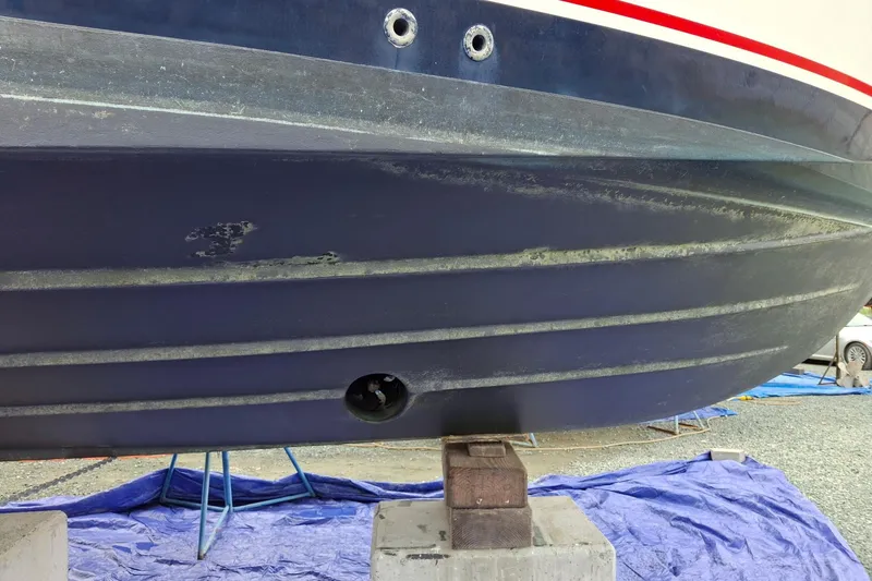 Slide: The Image of 2000 Riviera Enclosed Flybridge yacht in a boatyard, with a scenic background. - 45