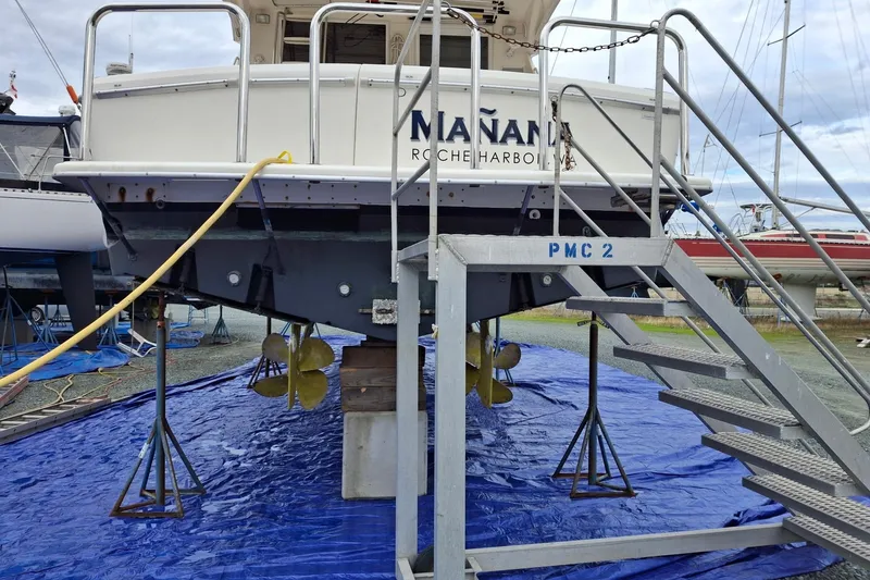 Slide: The Image of 2000 Riviera Enclosed Flybridge yacht docked at marina, showcasing sleek design and modern features. - 47