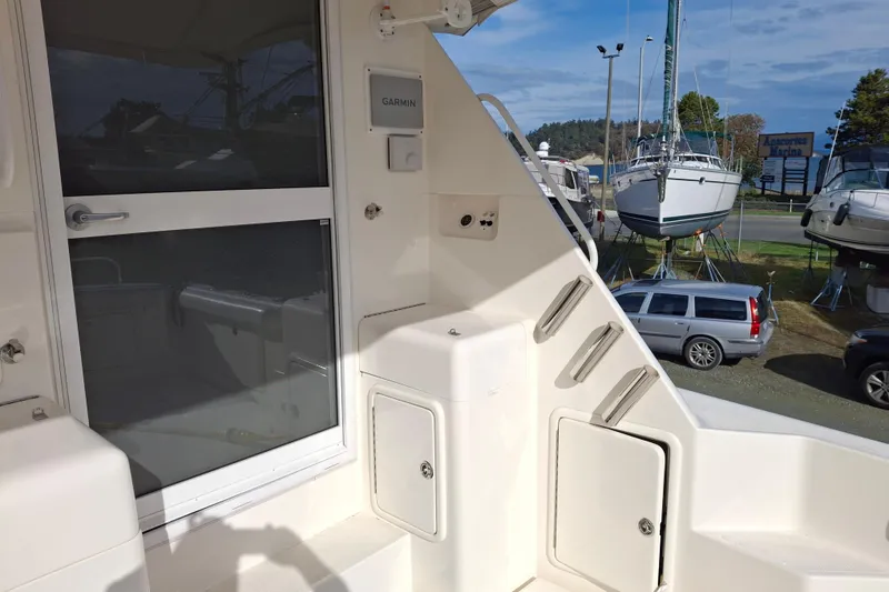 Slide: The Image of 2000 Riviera Enclosed Flybridge boat interior with control panel and door. - 5
