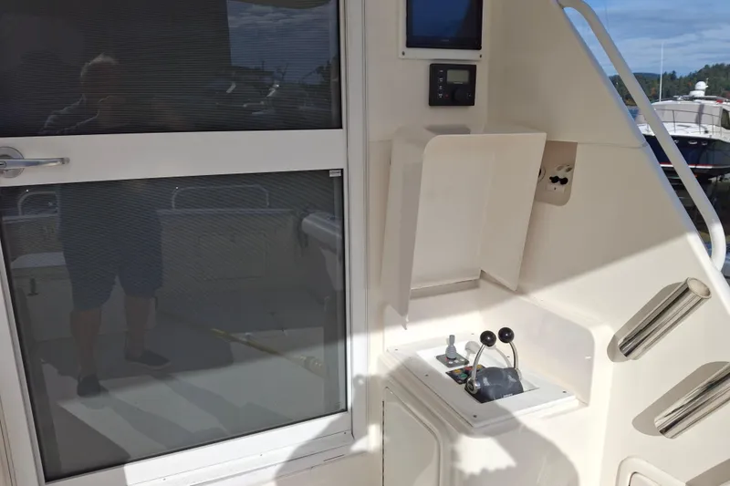 Slide: The Image of 2000 Riviera Enclosed Flybridge yacht interior with ladder and storage compartments. - 6