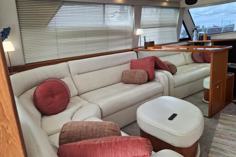Slide: The Image of Luxurious interior of 2000 Riviera Enclosed Flybridge yacht with plush seating and modern amenities. - 9