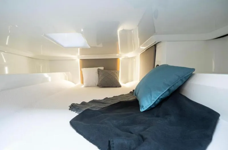 Slide: The Image of Cozy cabin interior of 2025 Yamarin 80DC boat with pillows and blanket. - 14