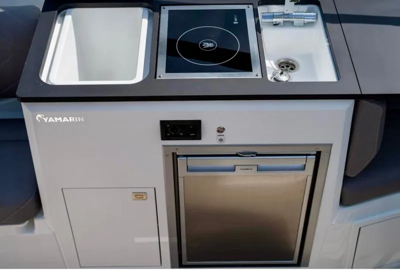 Slide: The Image of Modern Yamarin 80DC boat kitchen with sink, stove, and fridge, 2025 model. - 19