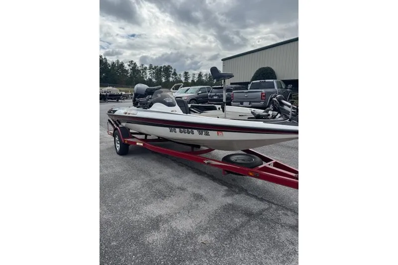Slide: The Image of 2001 Stratos 19SS Extreme boat on red trailer, parked outdoors. - 3