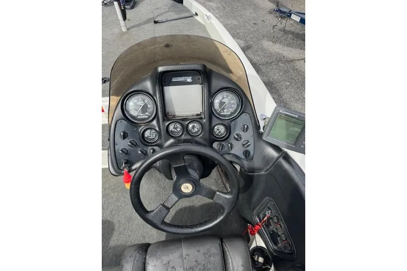 Slide: The Image of 2001 Stratos 19SS Extreme boat dashboard with steering wheel and gauges. - 9
