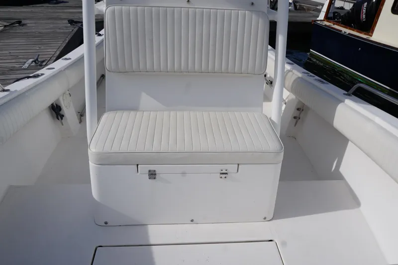 Slide: The Image of 2004 Regulator 24 Forward Seating boat interior with white cushioned seats. - 4