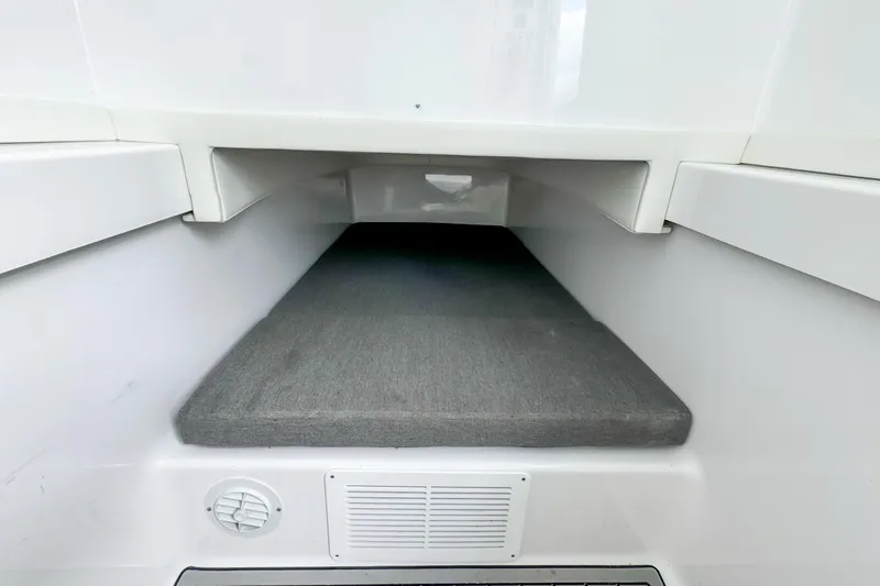 Slide: The Image of 2023 Front Runner 36 Center Console interior cabin with cushioned sleeping area. - 14