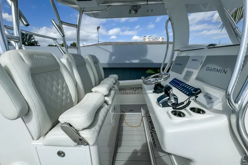 Slide: The Image of 2023 Front Runner 36 Center Console boat interior with white seating and advanced navigation equipment. - 20