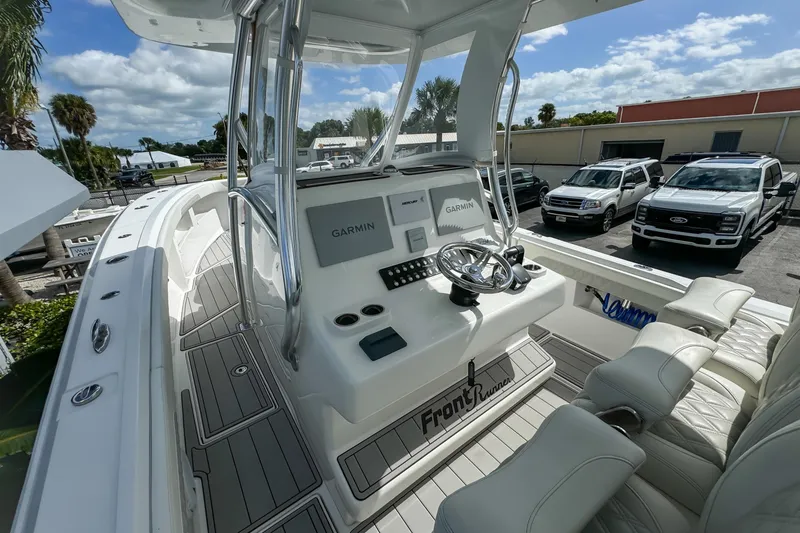 Slide: The Image of 2023 Front Runner 36 Center Console boat with Garmin navigation, sleek design, and comfortable seating. - 21