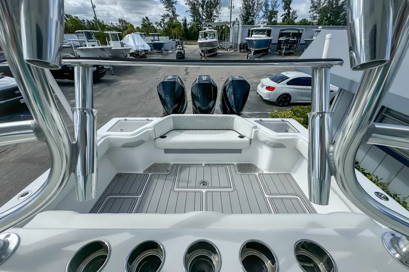 Slide: The Image of 2023 Front Runner 36 Center Console boat with triple engines, docked in a marina. - 25