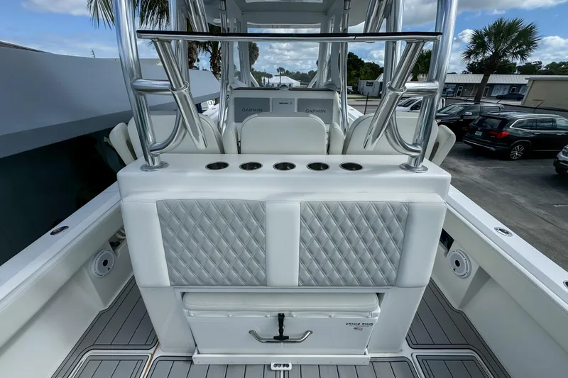 Slide: The Image of 2023 Front Runner 36 Center Console boat interior with diamond-stitched seating and rod holders. - 27