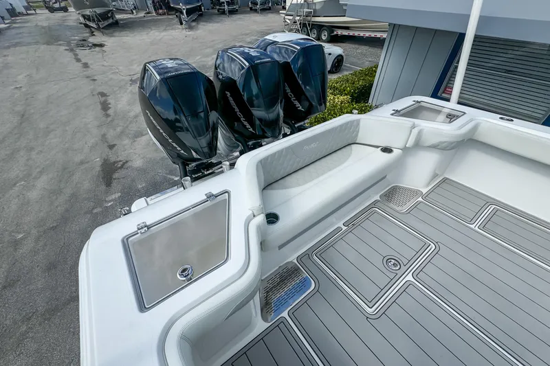 Slide: The Image of 2023 Front Runner 36 Center Console boat with triple Mercury engines, spacious deck, and seating area. - 31