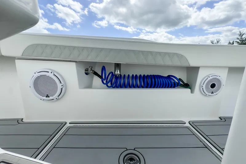 Slide: The Image of 2023 Front Runner 36 Center Console boat deck with speakers and coiled hose. - 39